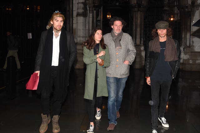Marco Pierre White leaves the Royal Courts of Justice in London accompanied by his children Marco White Jr, left, and Luciano White right