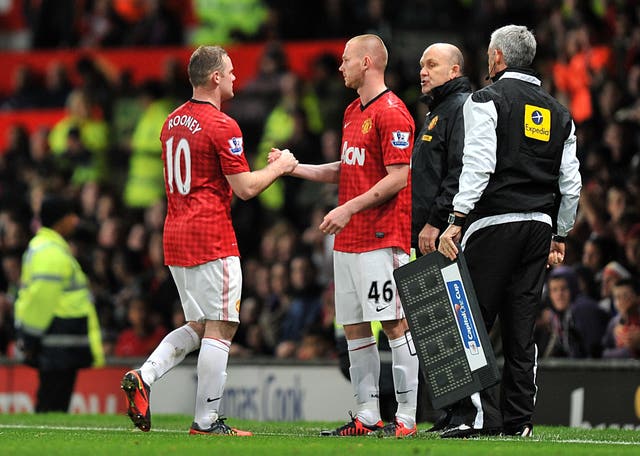Ryan Tunnicliffe shakes hands with Wayne Rooney before coming on for his Manchester United debut in 2011