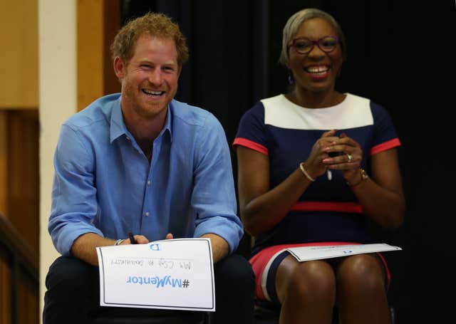 Harry smiling alongside Tessy Ojo, chief executive of the Diana Awards, in 2016 