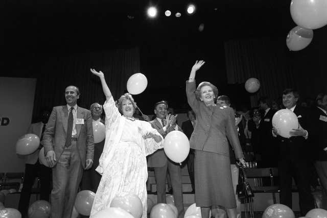 Celebrities cheering amid the balloons on stage, after they gathered to declare their support for the Tories at a 3,000 strong Family Rally. From left; Conservative Party Chairman Norman Tebbit, Denis Thatcher, impressionist Janet Brown, comedian Bob Monkhouse, Margaret Thatcher, and comedian Jimmy Tarbuck