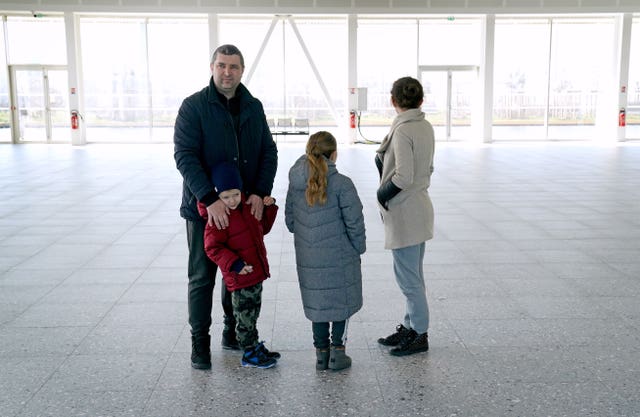 Yevgen Morgun, left), with his wife Anna and children Yehor, left, and Darya at the ferry terminal in Calais, France