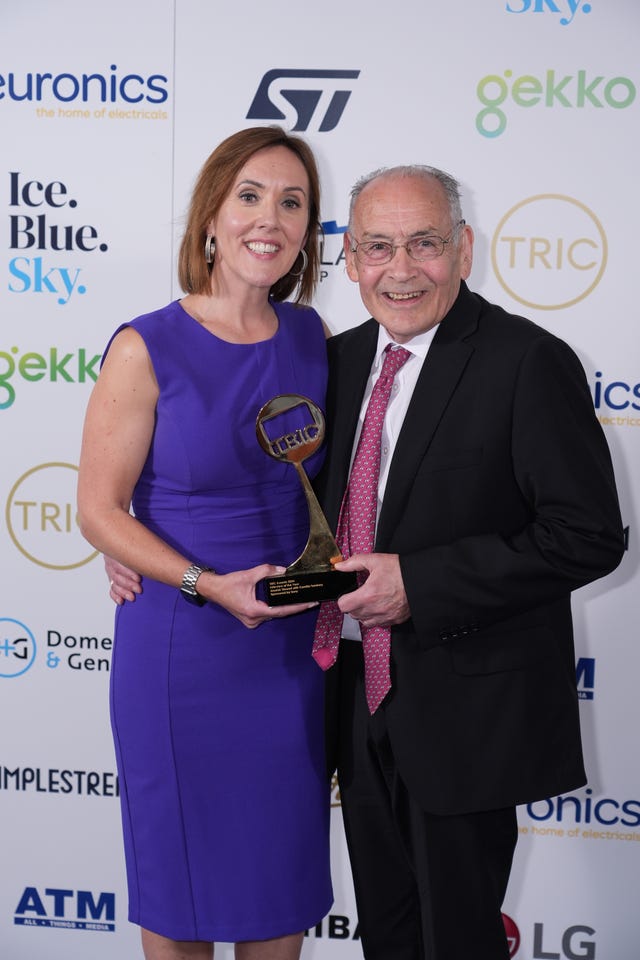 Camilla Tominey with Alastair Stewart holding an award