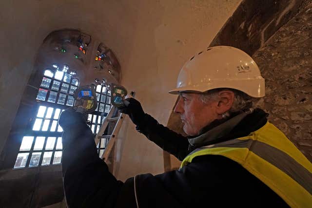 More jigsaw work on a stained glass window at the historic site (Owen Humphreys/PA)