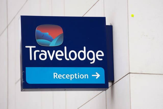 View of a Travelodge sign, with an arrow to reception