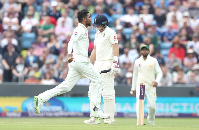 Joe Root shows his dejection as Mohammad Amir, left, celebrates taking his wicket