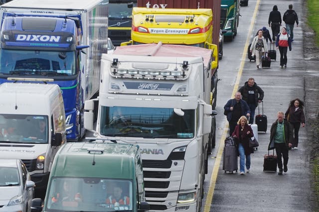 People with their luggage walk past the heavy traffic on Dublin’s M50