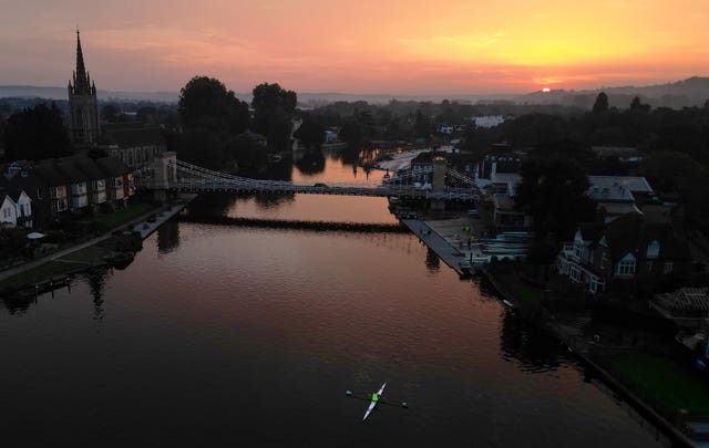 The sun rises over Marlow in Buckinghamshire and its Grade 1 listed bridge which spans the River Thames 