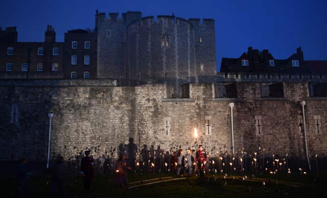 Beefeaters lighting the first of thousands of flames
