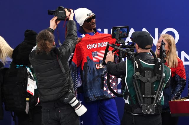 American rapper Snoop Dogg is presented with a custom USA jacket at the Cortina Curling Olympic Stadium