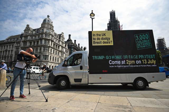 Demonstrators drive a Go Home van around Westminster