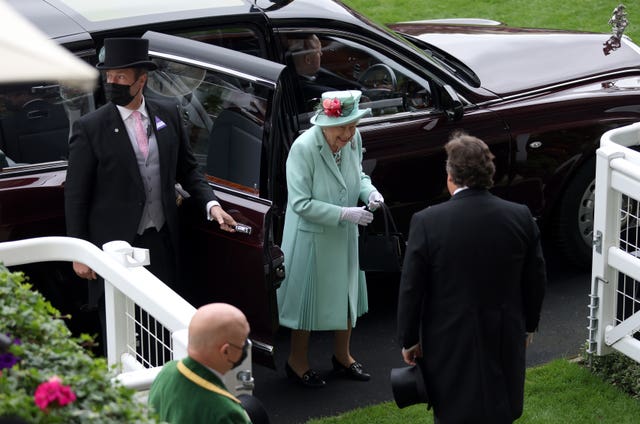 The Queen smiles as she arrives