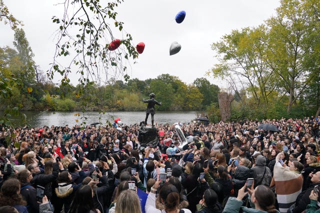 People releasing balloons during a vigil for Payne at Hyde Park in central London