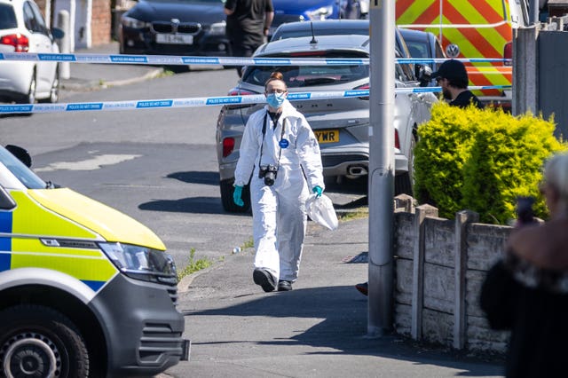 A police scenes of crime officer works at the scene in Southport, Merseyside, where a man has been detained and a knife seized after a number of people were injured in a reported stabbing