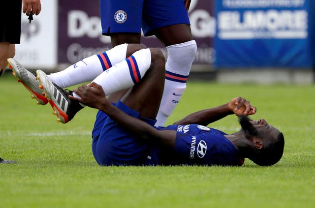 Tiemoue Bakayoko lies on his back on the pitch