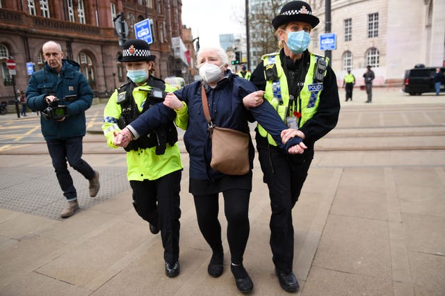 Police detain an NHS worker after breaking up a protest in Manchester over the proposed 1% pay rise for NHS workers from the Government
