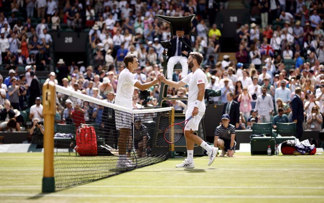 Alex De Minaur (left) and Liam Broady shake hands after their match 