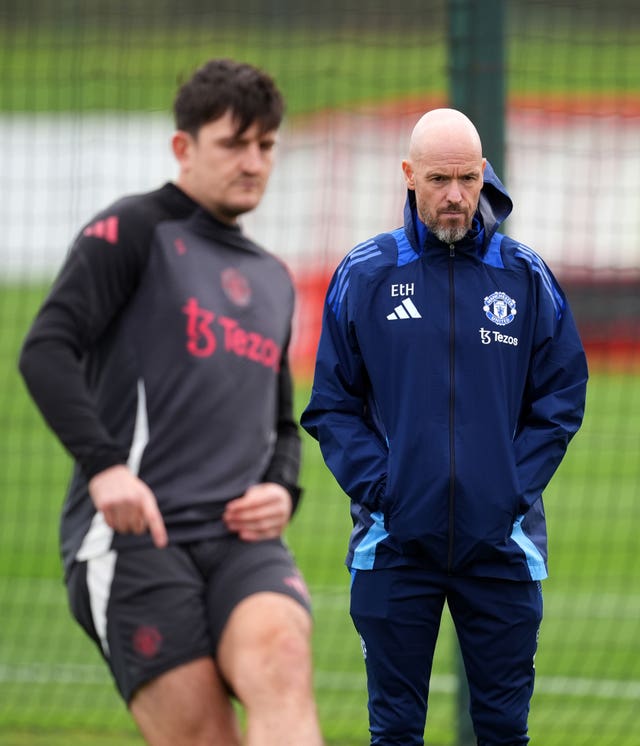 Harry Maguire, left, trains as manager Erik ten Hag watches on