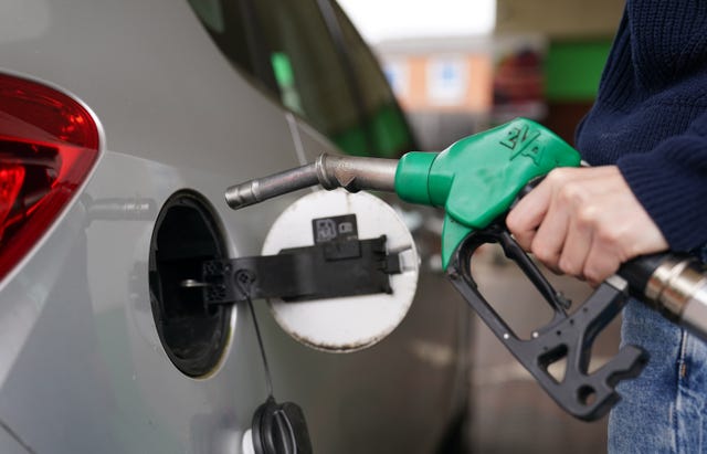 A person filling up a car