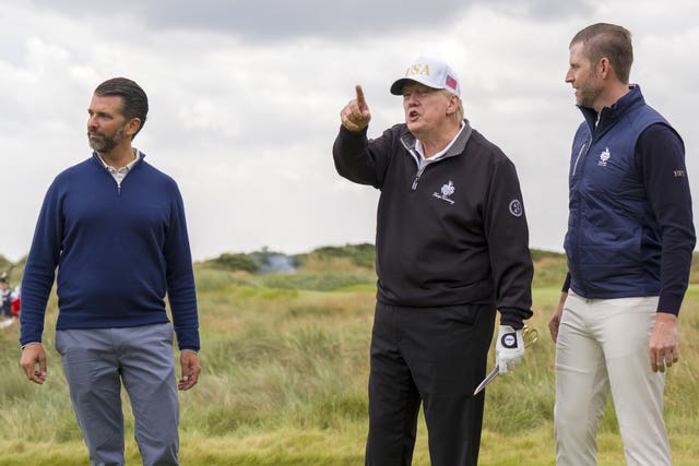 Donald Trump alongside his sons Donald Jnr and Eric on a golf course