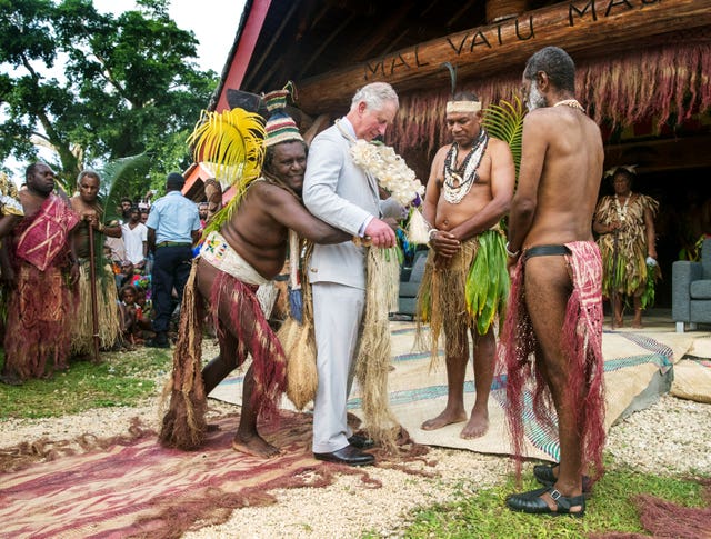 The Prince of Wales is given a grass skirt to wear in Vanuatu