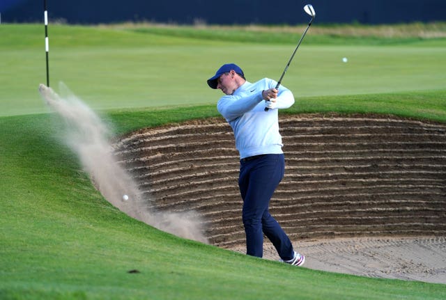 Rory McIlroy fails to chip out of a bunker on the 18th