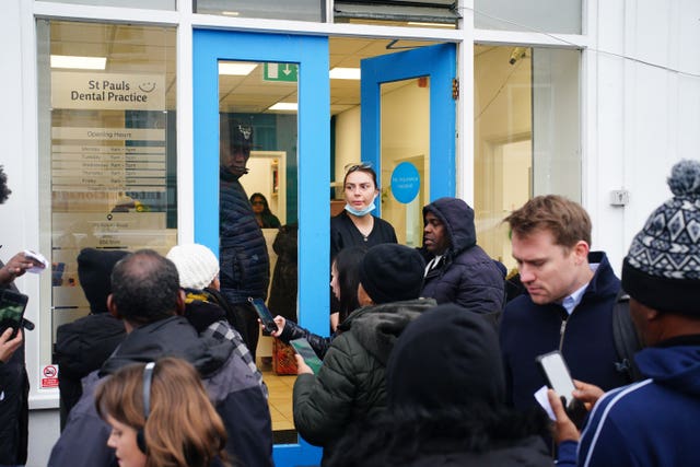 People in line outside the St Pauls Dental Practice on Ashley Road, Bristol