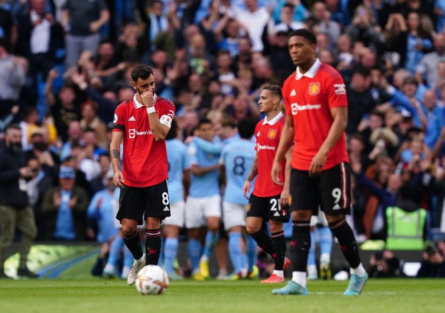 Manchester United players look on as Manchester City celebrate their fifth goal