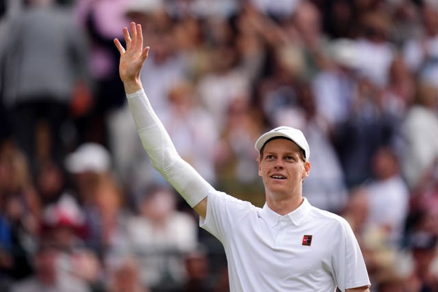 Jannik Sinner waves at the Court One crowd as he celebrates his victory over Ben Shelton