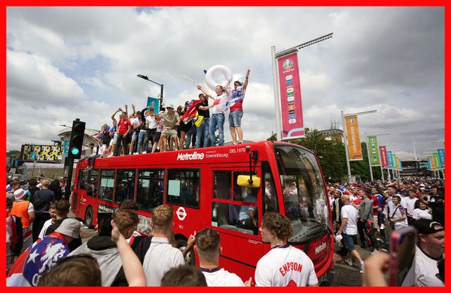 England fans standing on top of a bus