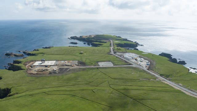 Aerial view of a space launch site on an island, with the sea beyond