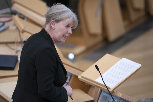 Shona Robison standing while speaking in Holyrood