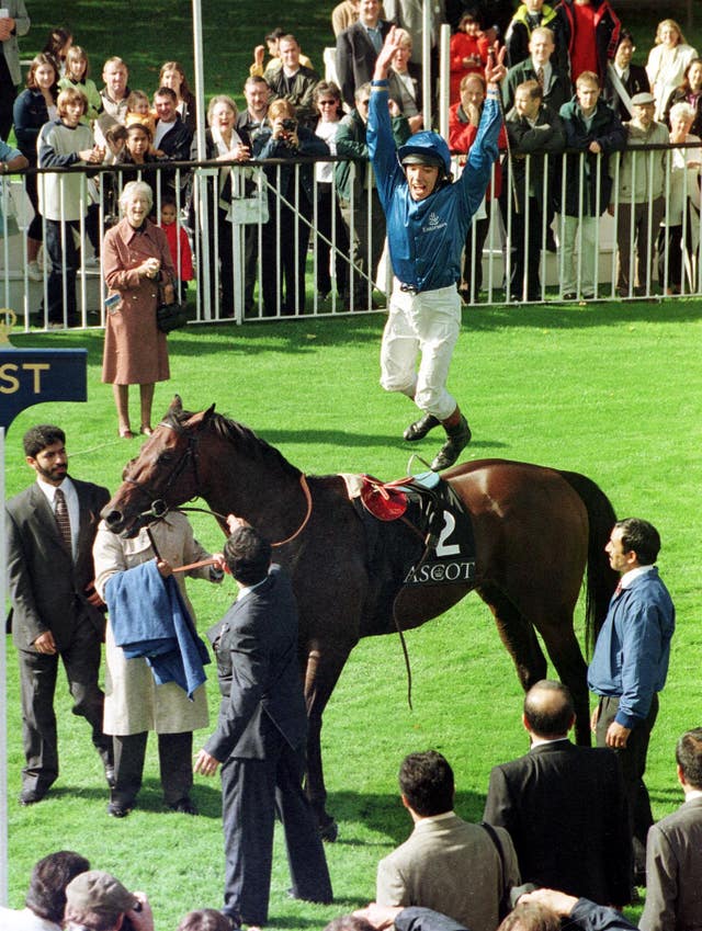 Frankie Dettori leaps from Dubai Millennium after winning the Queen Elizabeth II Stakes at Ascot