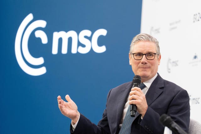 Sir Keir Starmer speaking into a microphone at the Munich Security Conference