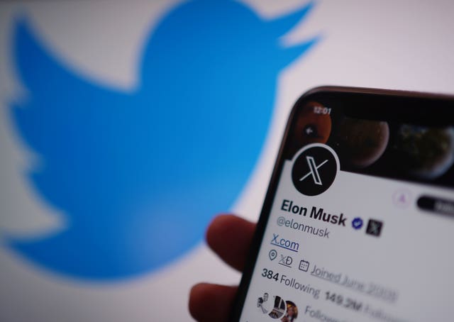 A phone displays the Twitter account for Elon Musk