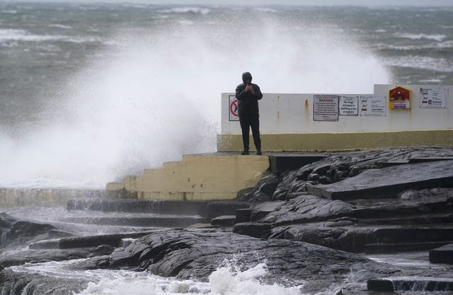 A man takes photos of the waves at Blackrock Diving Board, Salthill, Co Galway 