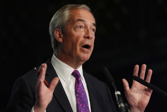 Nigel Farage raises his hands