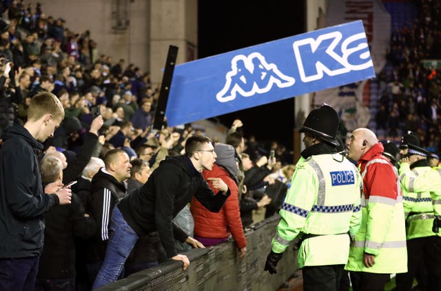 Wigan Athletic’s fans clashed with police after the final whistle (Tim Goode/Empics)