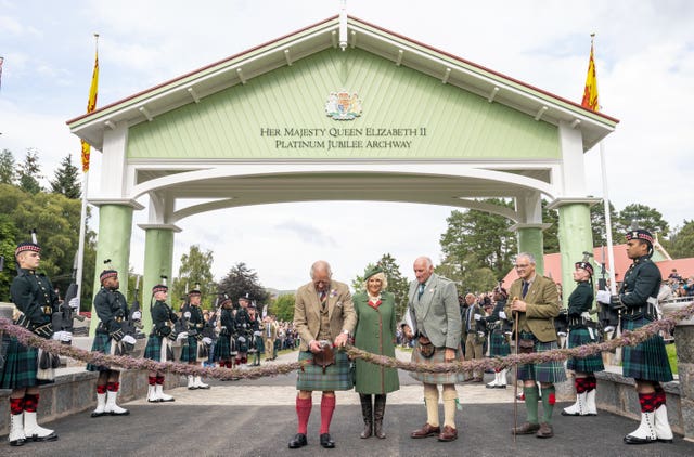Charles and Camilla officially open the Queen Elizabeth Platinum Jubilee Archway during the Braemar Royal Highland Gathering