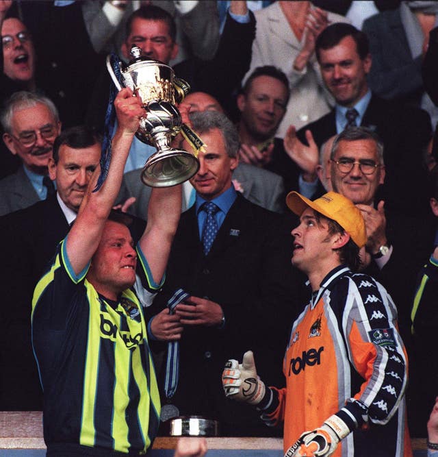 Andy Morrison, left, and Nicky Weaver lift the trophy after Manchester City win promotion to the second tier