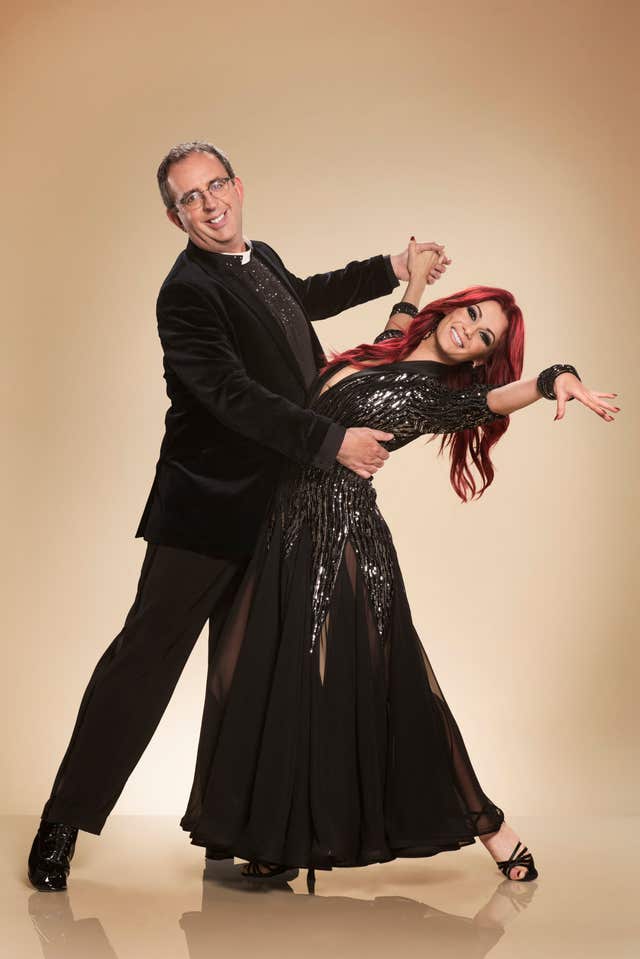 Richard Coles holds Dianne Buswell in a dancing pose