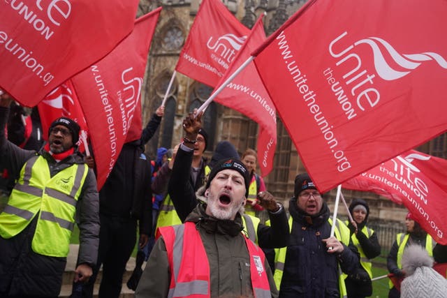 Workers from Tata’s Port Talbot steelworks wave red Unite union flags on College Green, in Westminster