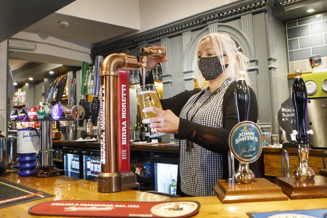 Melanie Scott pulling a pint at the Black Bull pub in Haworth, West Yorkshire