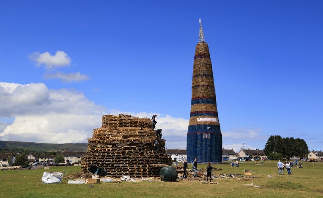 A bonfire being built out of pallets