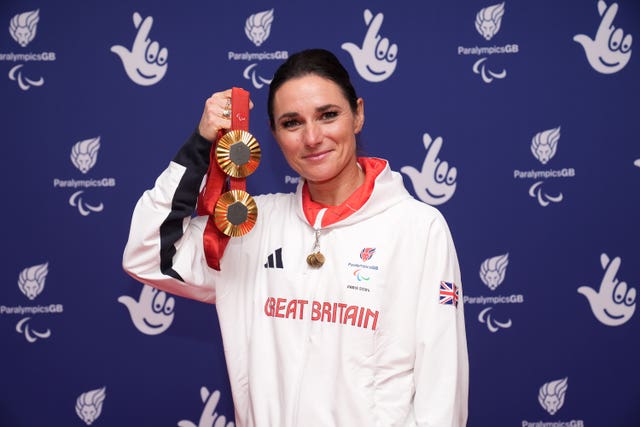 Sarah Storey holds up her two Paralympic gold medals