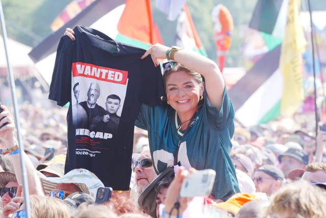 A Kneecap supporter holds up a T-shirt during their gig