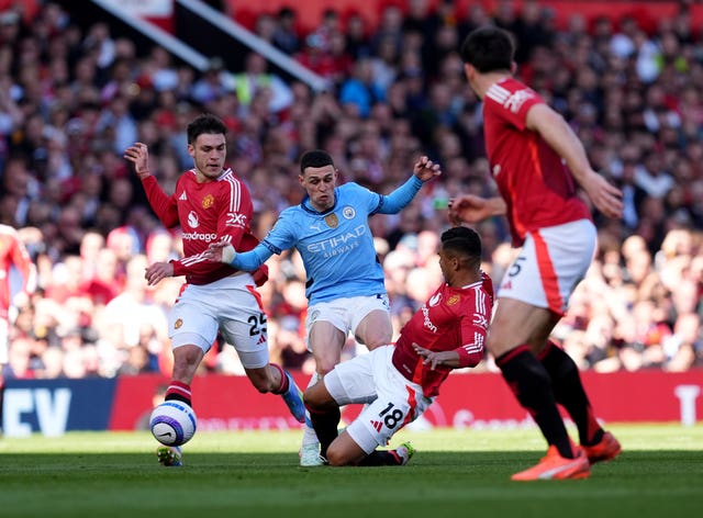 Foden (centre) is tackled by Manchester United’s Casemiro (centre right) during the Premier League match at Old Trafford in April