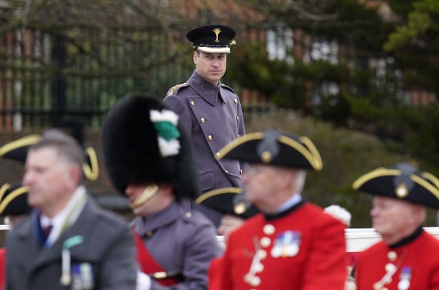 The Prince of Wales watches the march past 