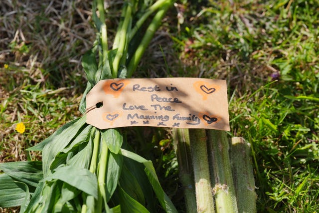 A message attached to a floral tribute left near the scene in Ashlyn Close 