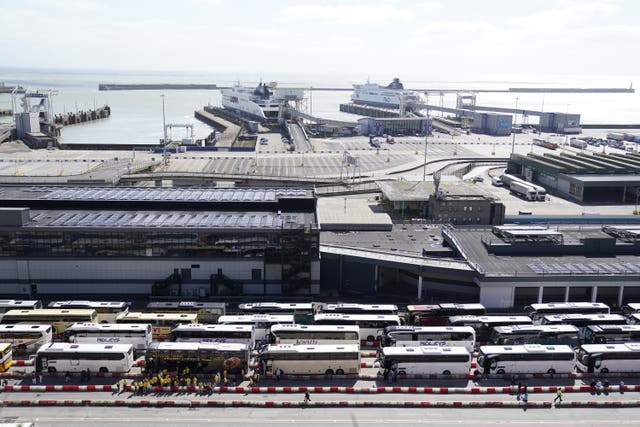 Passengers by their coaches as they wait to enter the Port of Dover in Kent on Sunday (Andrew Matthews/PA)
