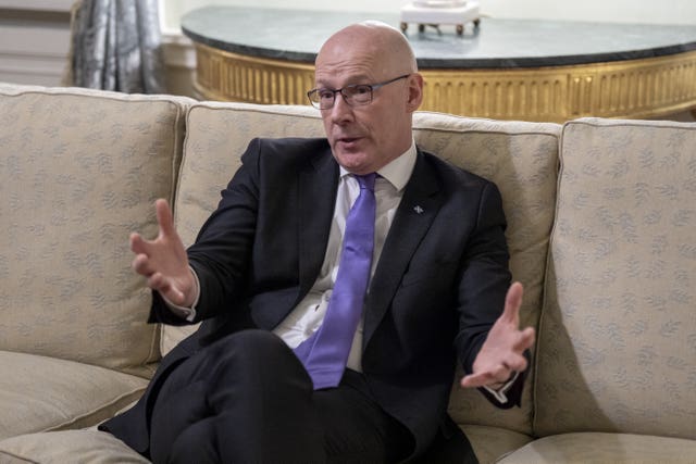 John Swinney answers questions while sitting on a sofa at Bute House in Edinburgh